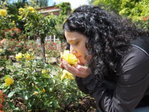 Pretty brunette smelling roses