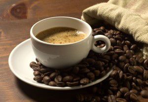 coffee cup and grains on wooden table