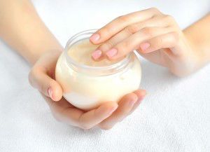 Beautiful woman hands with cream