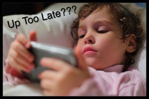 Little girl in bed with hendheld computer