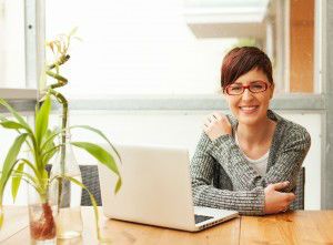 Portrait of beautiful woman working on laptop on terrace