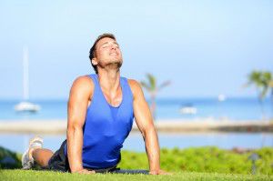 Fitness yoga man in cobra pose stretching abs