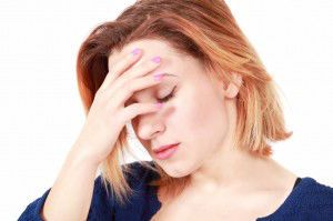 Stressed woman holding head, face profile