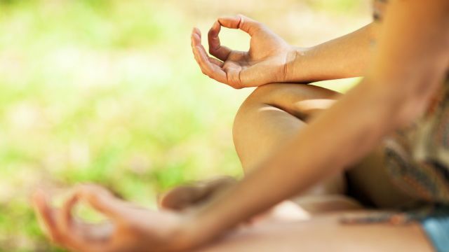 Young female meditate in nature.Close-up image.