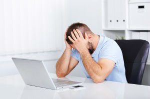 Young business man under stress with headache