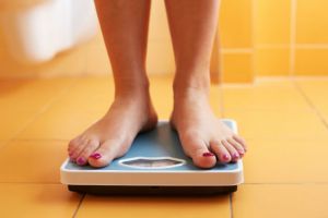 A pair of female feet on a bathroom scale