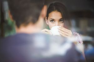 Young couple on first date drinking coffee