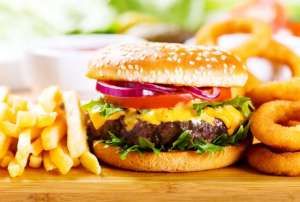 hamburger with fries and onion rings