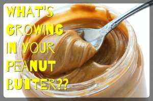 an open jar of peanut butter with spoon