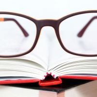 Eyeglasses closeup on open book