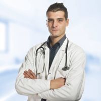 Portrait of smiling male doctor on the white