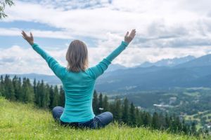 Woman Meditate at the Mountains