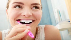 Woman brushing cleaning teeth. Oral hygiene.