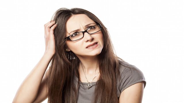 young woman with questionable gesture scrape the hair