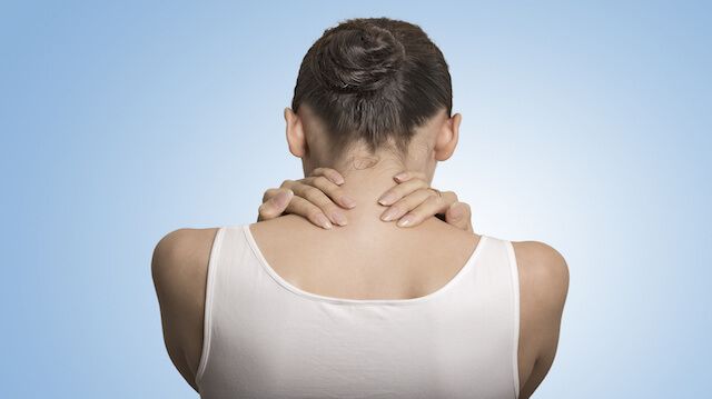 back view tired female massaging her painful neck