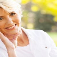 lovely middle aged woman sitting at the park