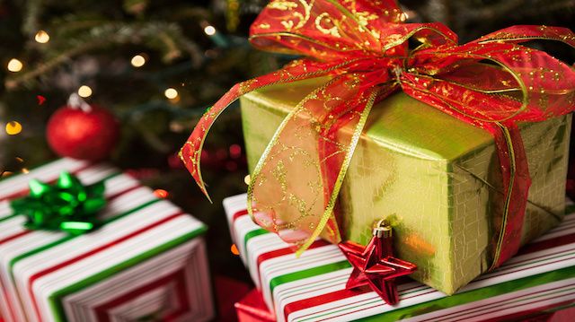 Stack of wrapped Christmas presents under a tree