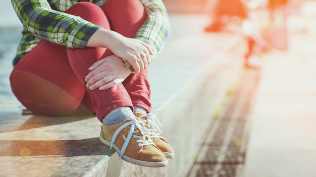 Yellow sneakers on girl legs in hipster style