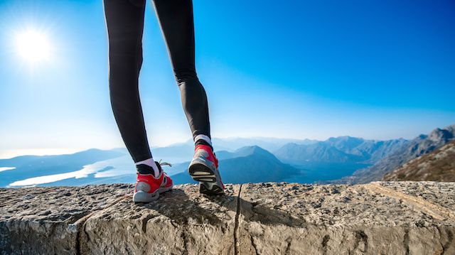 Sporty legs on the mountain hill