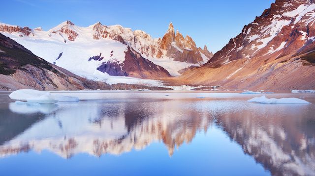 Cerro Torre, Patagonia, Argentina reflected in lake below, at sunrise