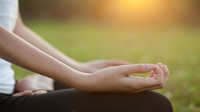 Young Woman doing Yoga Exercises Outdoor