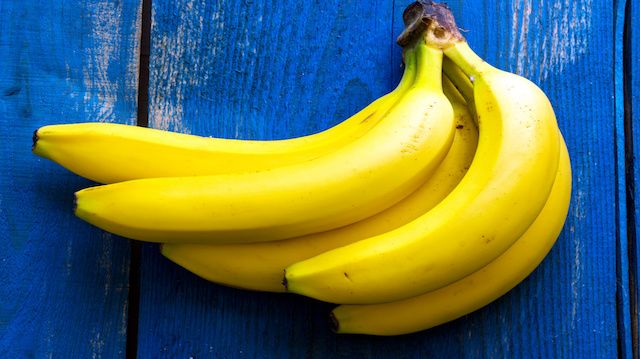 Fresh bananas on wooden background