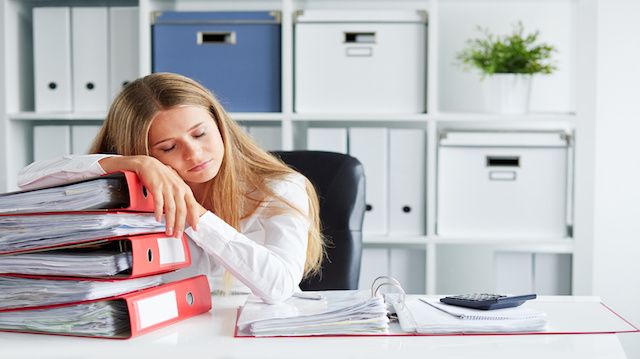 Tired woman sleeping in the office