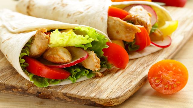 chicken burrito with radishes, sweet peppers and salad