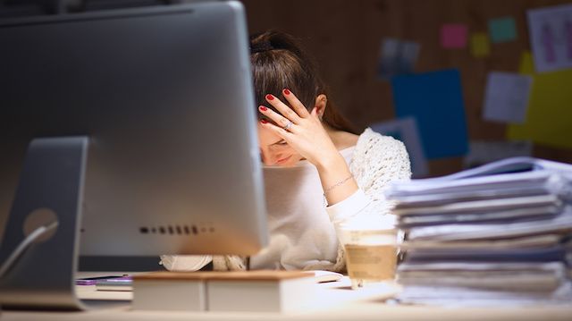 Young and beautiful businesswoman tired from work in the office