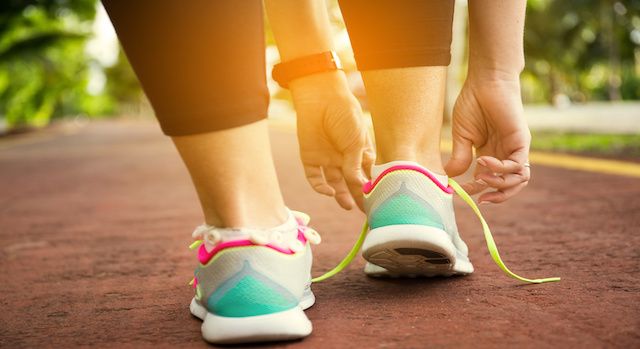 Sport woman tying shoe laces