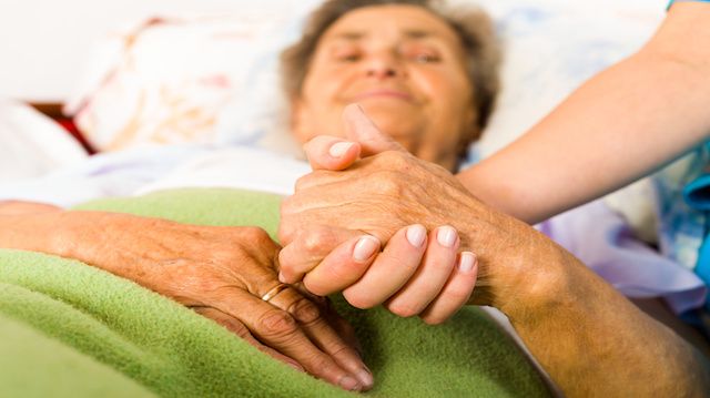 Caring Nurse Holding Hands