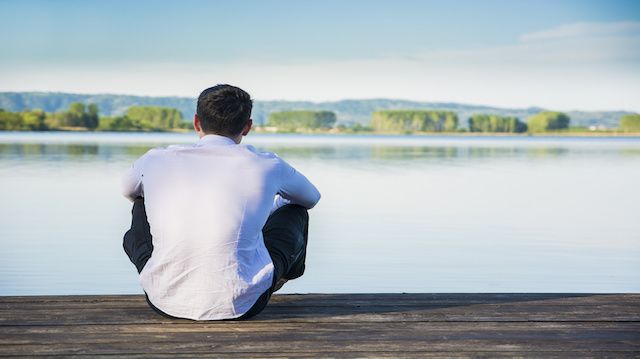 Handsome young man on a lake in a sunny, peaceful day