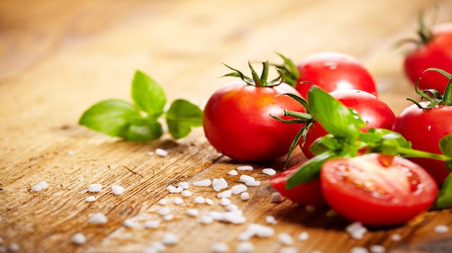 Tomatoes lying on old table. Diet food