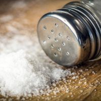 Salt on wooden background