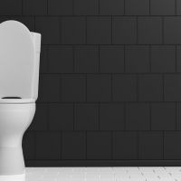 White toilet bowl on black wall background, copy space. 3d illustration