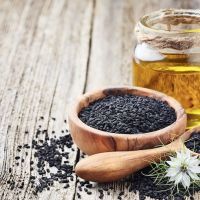 Black cumin oil with seeds and flower nigella sativa