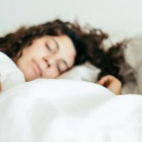 woman sleeping in bed close up blurred