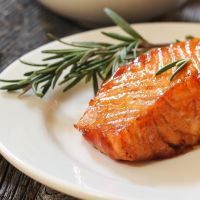Pan fried salmon with Rosemary garnish, selective focus
