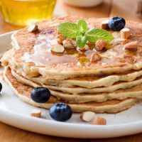 Gluten free almond pancakes with blueberries and honey.